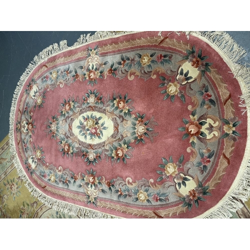 837 - A large oval woollen rug - 250 x 156 cm, together with a rectangular rug 183 x 122cm and one similar... 