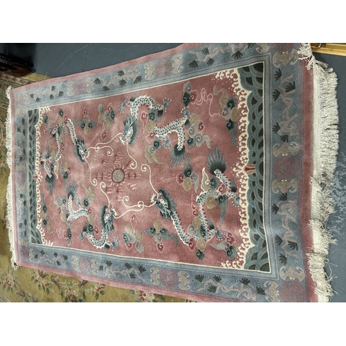 837 - A large oval woollen rug - 250 x 156 cm, together with a rectangular rug 183 x 122cm and one similar... 