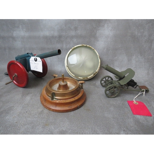 107 - TWO VINTAGE MODEL TOY CANNONS, a trench art ashtray and military light fitting with etched glass len... 