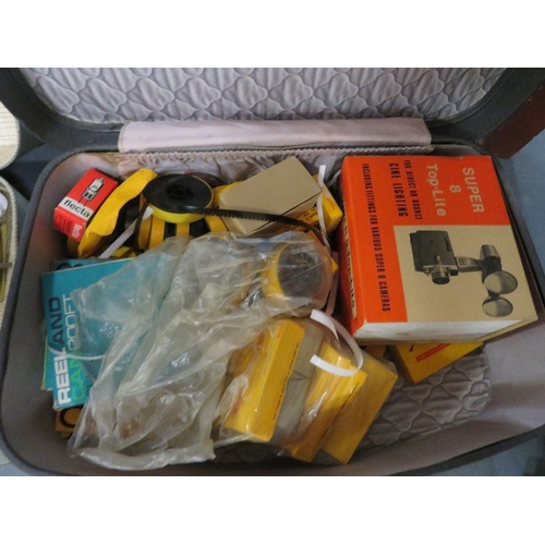 153 - A vintage portable record player, a quantity of super 8 film, dolls etc