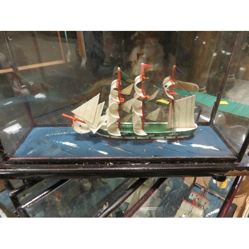 196 - Two trays of model ships in bottles and display cases together with a tray of porcelain bear money b... 