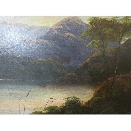 37 - Two gilt framed oils on panel depicting a street scene and a mountainous lake scene (2)