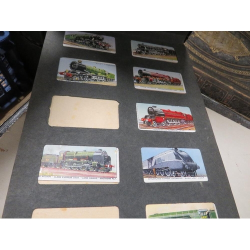 245 - A tray of phone cards, cigarette cards, Stanley Gibbons stamp album, football cards etc