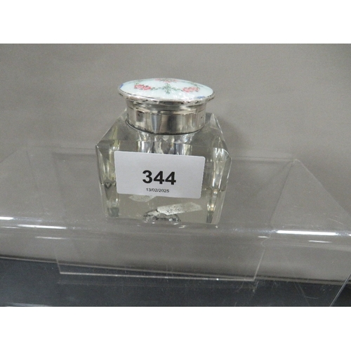 344 - A hallmarked silver and enamel mounted glass desk inkwell, the lid decorated with roses and foliage ... 