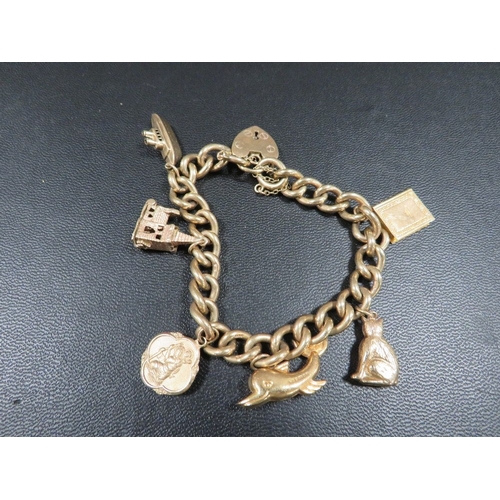 369 - A hallmarked 9 carat gold curb link charm bracelet adorned with six charms approx weight  44.9g