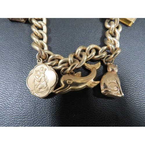 369 - A hallmarked 9 carat gold curb link charm bracelet adorned with six charms approx weight  44.9g