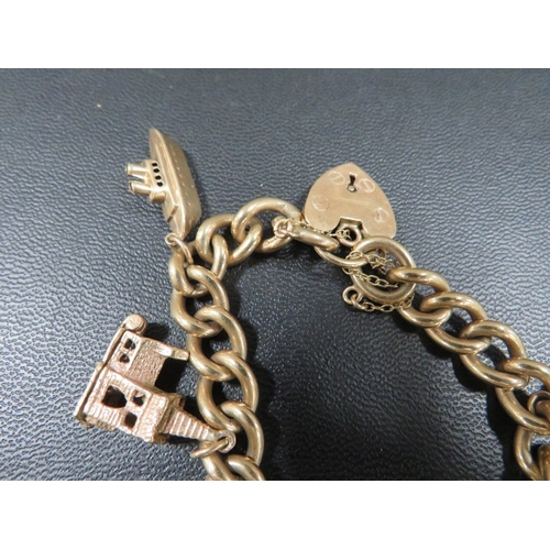 369 - A hallmarked 9 carat gold curb link charm bracelet adorned with six charms approx weight  44.9g