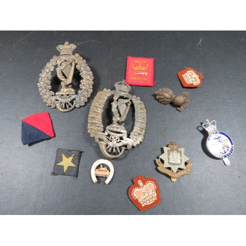 433 - A bag of military badges, to include 2 Royal Irish Rifles helmet plates