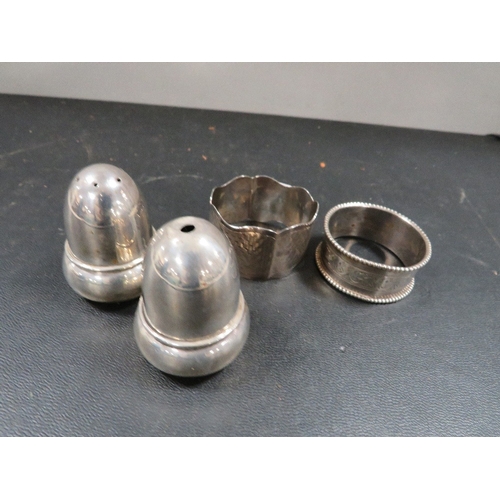 436 - A hallmarked silver salt and pepper with two silver napkin rings approx combined weight 61g