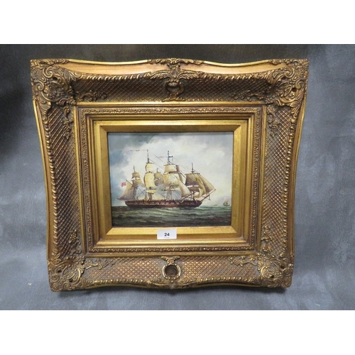 A gilt framed picture of a Naval battleship