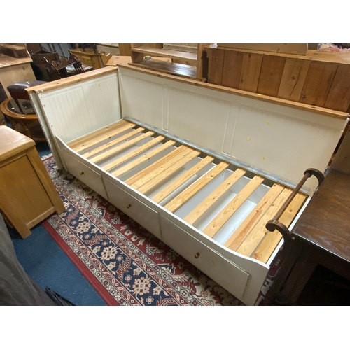An Ikea style cream single bed