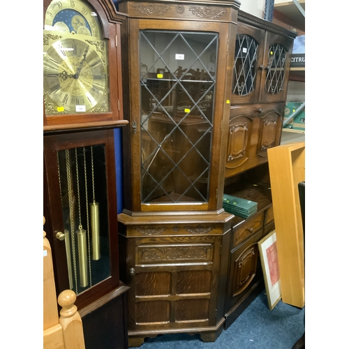 An oak carved leaded corner cabinet