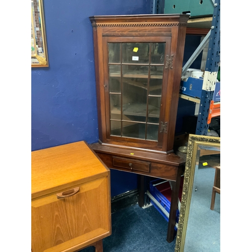 An antique mahogany inlaid corner cabinet on stand