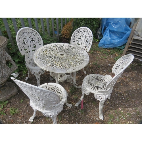 601 - A cast aluminium patio set comprising a table & four chairs
