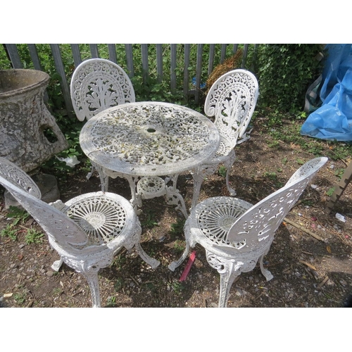 601 - A cast aluminium patio set comprising a table & four chairs