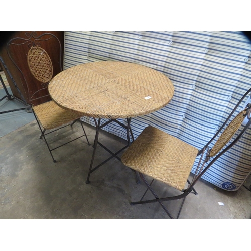 644 - A wrought iron and wicker folding patio garden set comprising a table and two chairs