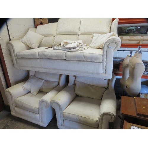 647 - A cream wing backed style 10 cushion sprung edged three piece suite with piped edges and reversible ... 