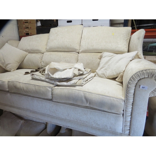 647 - A cream wing backed style 10 cushion sprung edged three piece suite with piped edges and reversible ... 