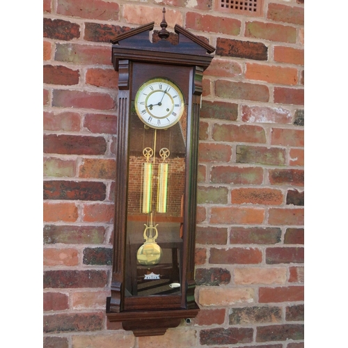 711 - A tall slender 8 day gong strike Vienna wall clock by Fenclocks of Suffolk, with Hermle movement and... 