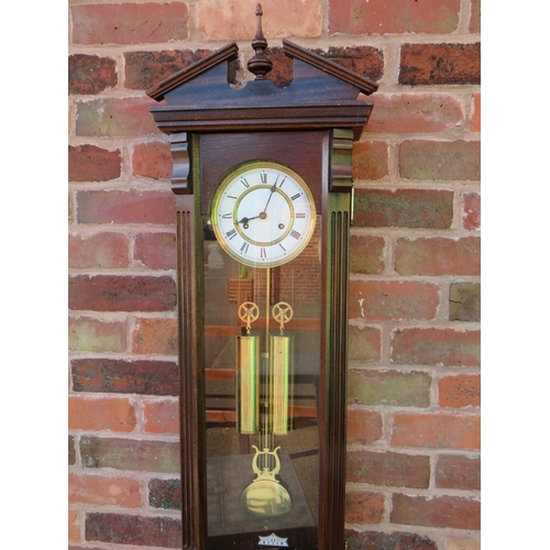 711 - A tall slender 8 day gong strike Vienna wall clock by Fenclocks of Suffolk, with Hermle movement and... 