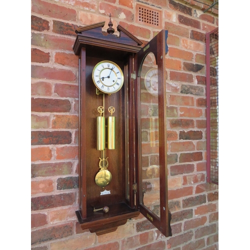 711 - A tall slender 8 day gong strike Vienna wall clock by Fenclocks of Suffolk, with Hermle movement and... 