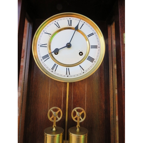 711 - A tall slender 8 day gong strike Vienna wall clock by Fenclocks of Suffolk, with Hermle movement and... 