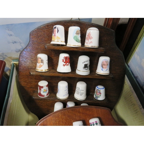 137 - A tray of collectables to include spoons, thimbles etc