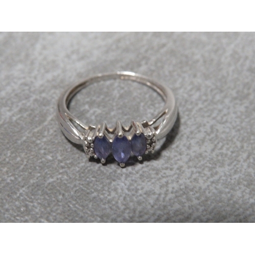 310 - A hallmarked 9 carat white gold Tanzanite and Diamond ring approx weight 2.2g ring size O½