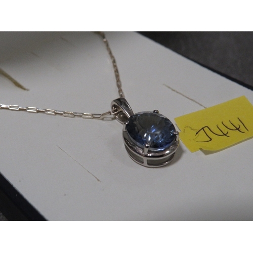 319 - A blue stone pendant on silver mount and chain