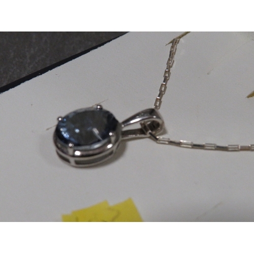 319 - A blue stone pendant on silver mount and chain