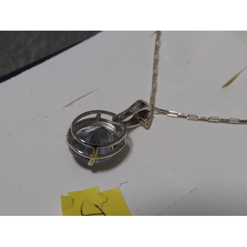 319 - A blue stone pendant on silver mount and chain