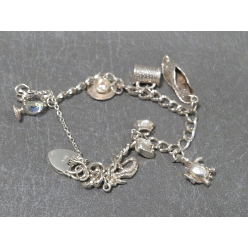 320 - A hallmarked silver charm bracelet approx weight 22.1g