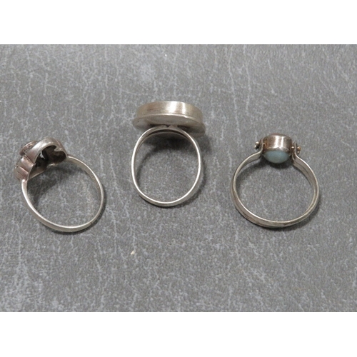 324 - Three dress rings to include a silver turquoise style example