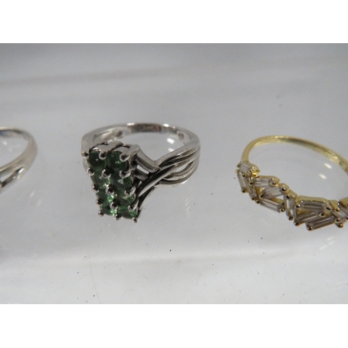 328 - Four dress rings to include a silver amber style example