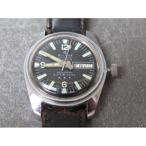 A WILSON DAY DATE 17 JEWELLED MILITARY WRISTWATCH, on leather strap, dial Dia. 3 cm