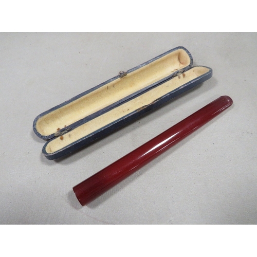 A vintage Cherry Amber bakelite cigarette / cheroot holder in original fitted box L 13cm W 12.7g