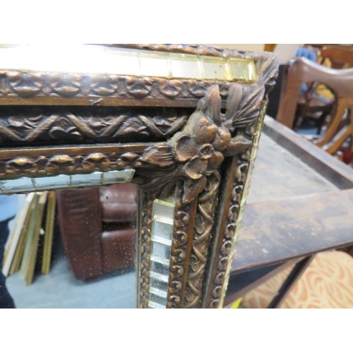 49 - A large vintage mirror with an unusual decorative gilt and mirrored effect frame