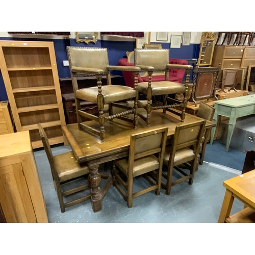 A Jacobean oak style oak drawleaf table and eight chairs