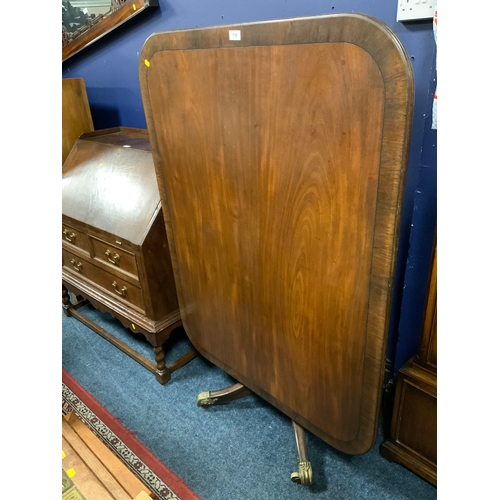 A Georgian mahogany cross banded tilt top table