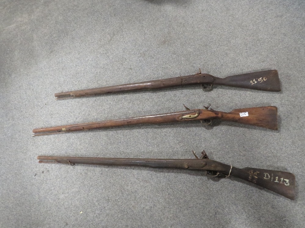 Two antique long bore flintlock rifles together with a pin fire rifle A ...