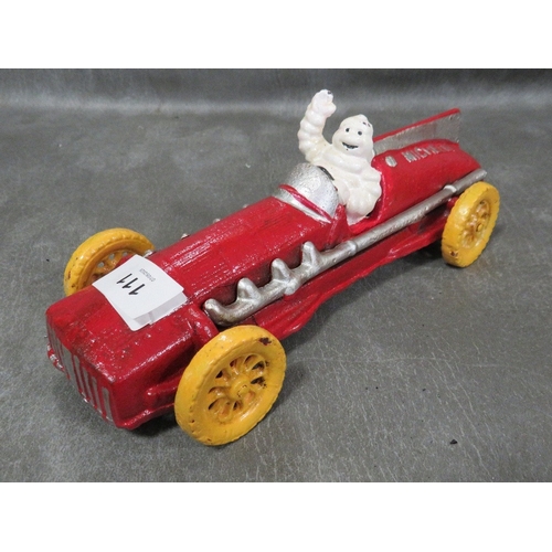 111 - **A cast metal model of a Michelin figure in vintage style red car**