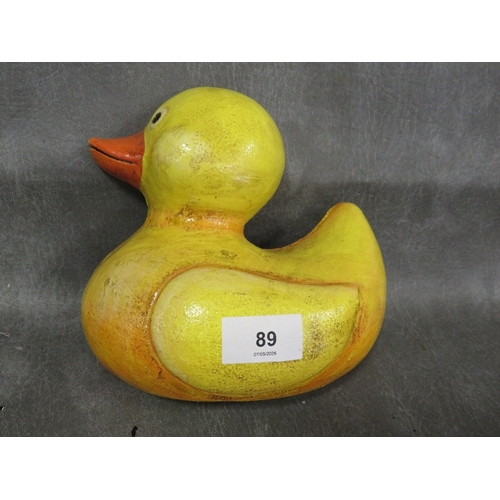 89 - **A doorstop in the form of a yellow duck**