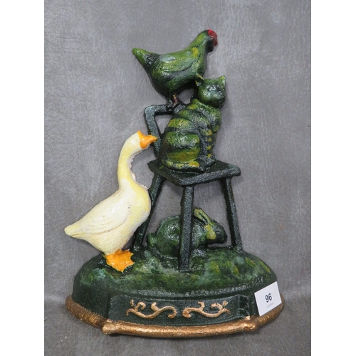 96 - **A cast metal door stop with various animals seated on a chair etc.**