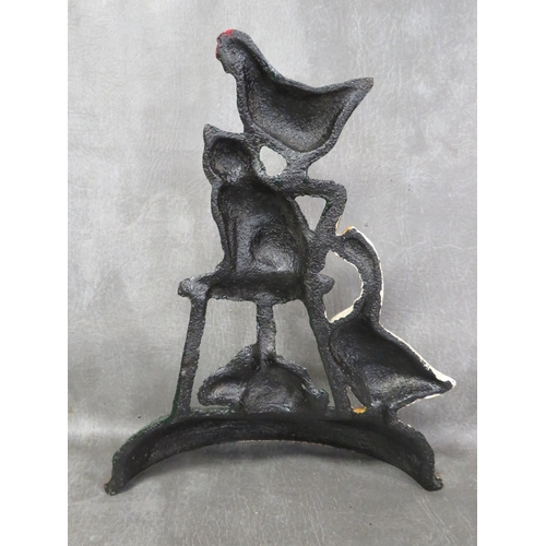 96 - **A cast metal door stop with various animals seated on a chair etc.**