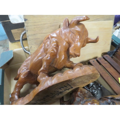 152 - A tray of assorted treen to include a carved model of a bull and a miniature garden bench and table