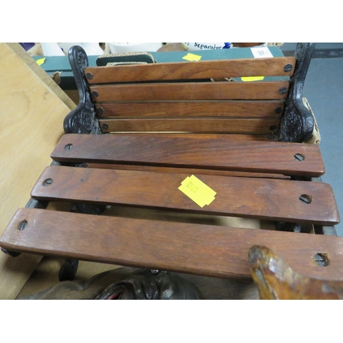 152 - A tray of assorted treen to include a carved model of a bull and a miniature garden bench and table