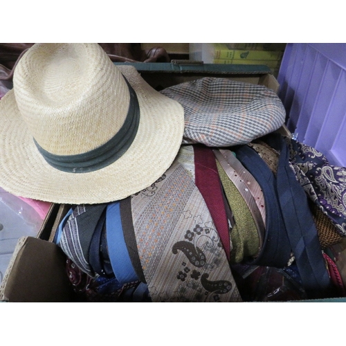 155 - Four trays of assorted textiles to include cushions, hats and shirts