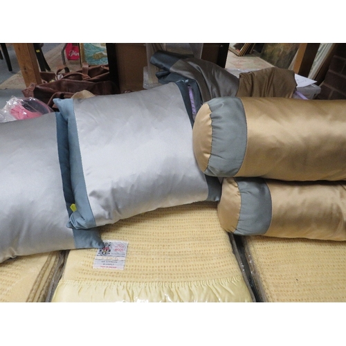 155 - Four trays of assorted textiles to include cushions, hats and shirts