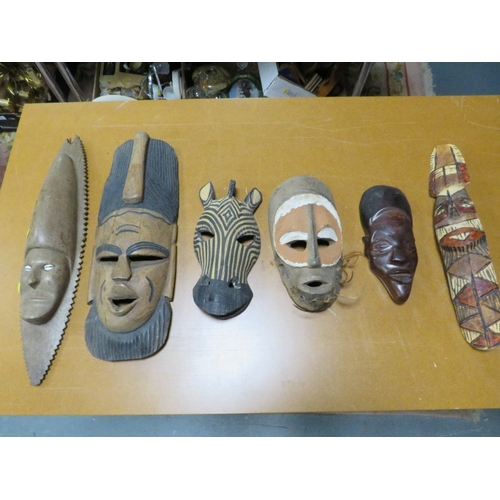Six various African tribal art masks including one with cowrie shell eyes
