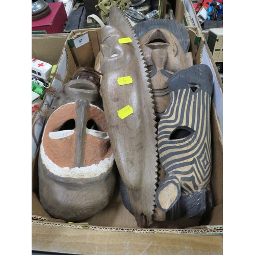 Six various African tribal art masks including one with cowrie shell eyes